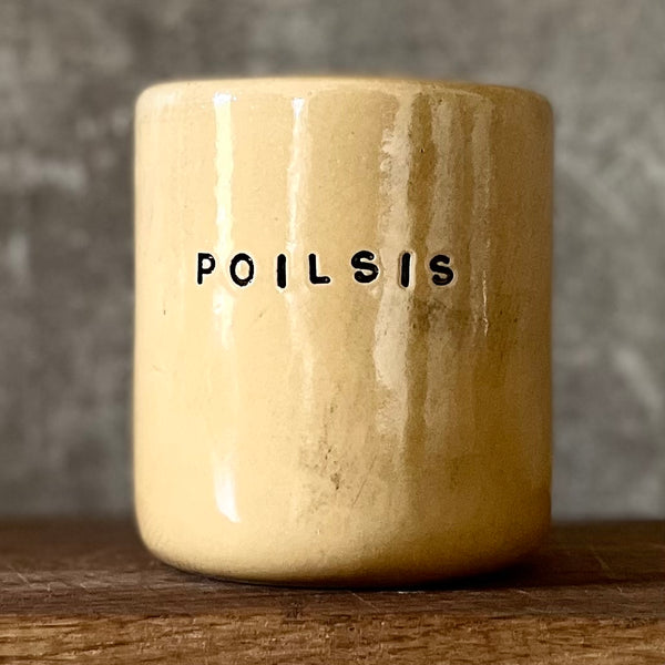 Yellow tumbler mug with word in Lithuanian POILSIS