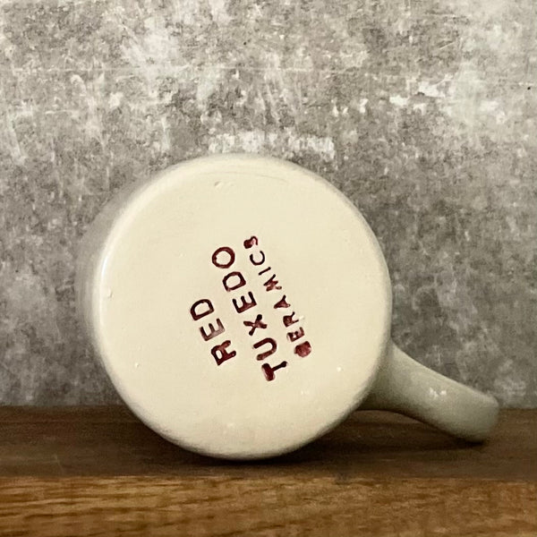 Speckled mug about champagne and the sea