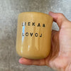 Geltonas puodelis "LIEKAM LOVOJ" 150 ml