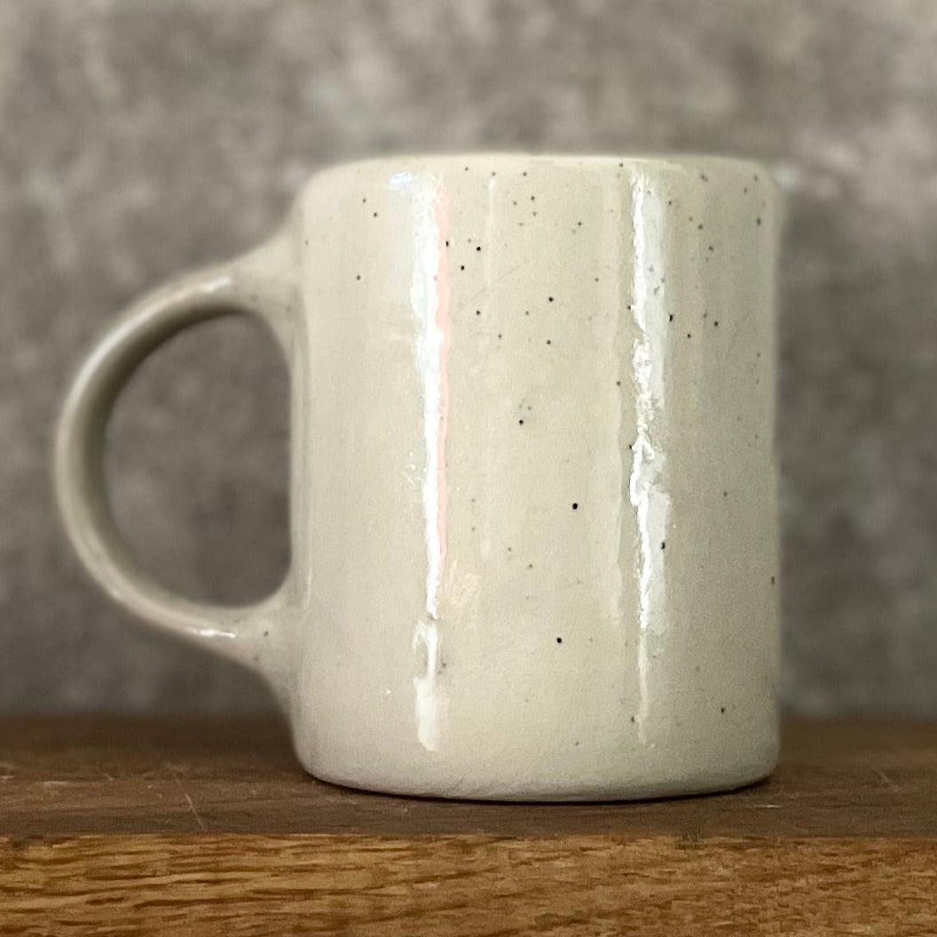 Speckled mug about champagne and the sea