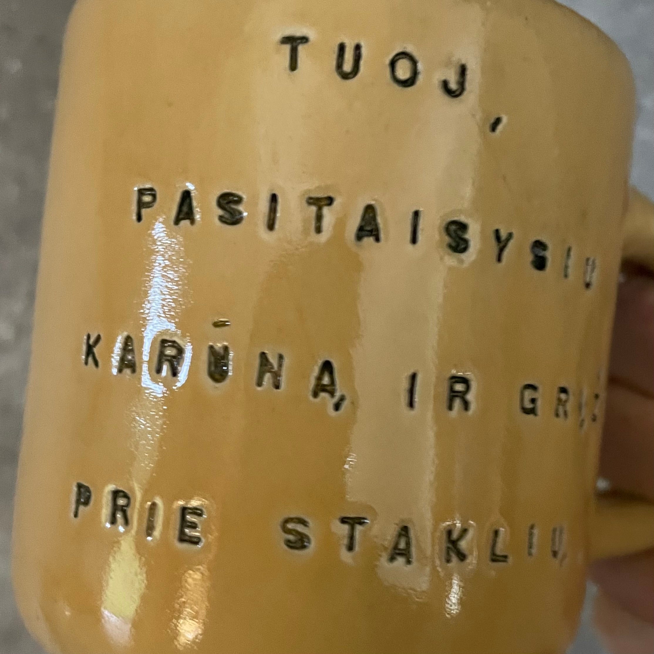 Yellow mug with words in Lithuanian
