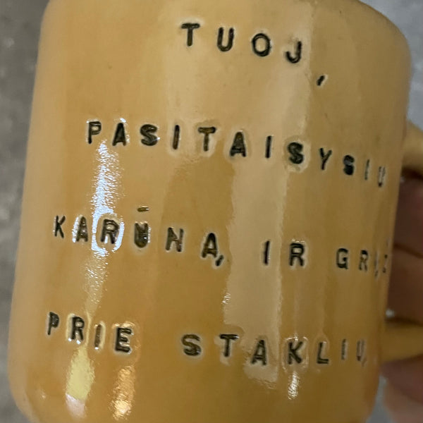 Yellow mug with words in Lithuanian