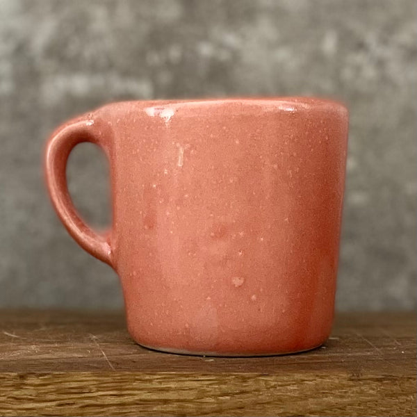 Small red mug with words in Lithuanian