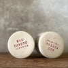 A set of small mugs with words in Lithuanian