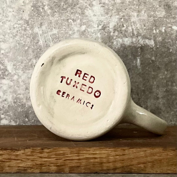 Puodelis su užrašu apie balansą su ąsele