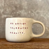Puodelis su citata “No artist tolerates reality"