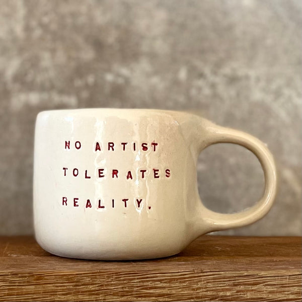 Puodelis su citata “No artist tolerates reality"