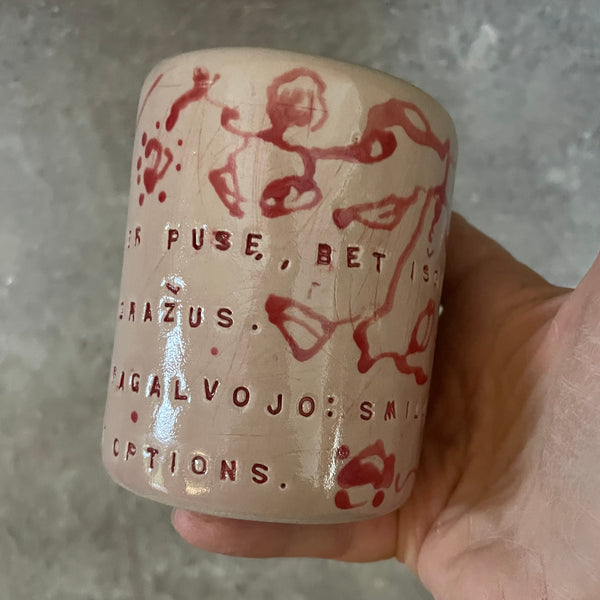 Rausvas gėlėtas puodelis su ilgu tekstu