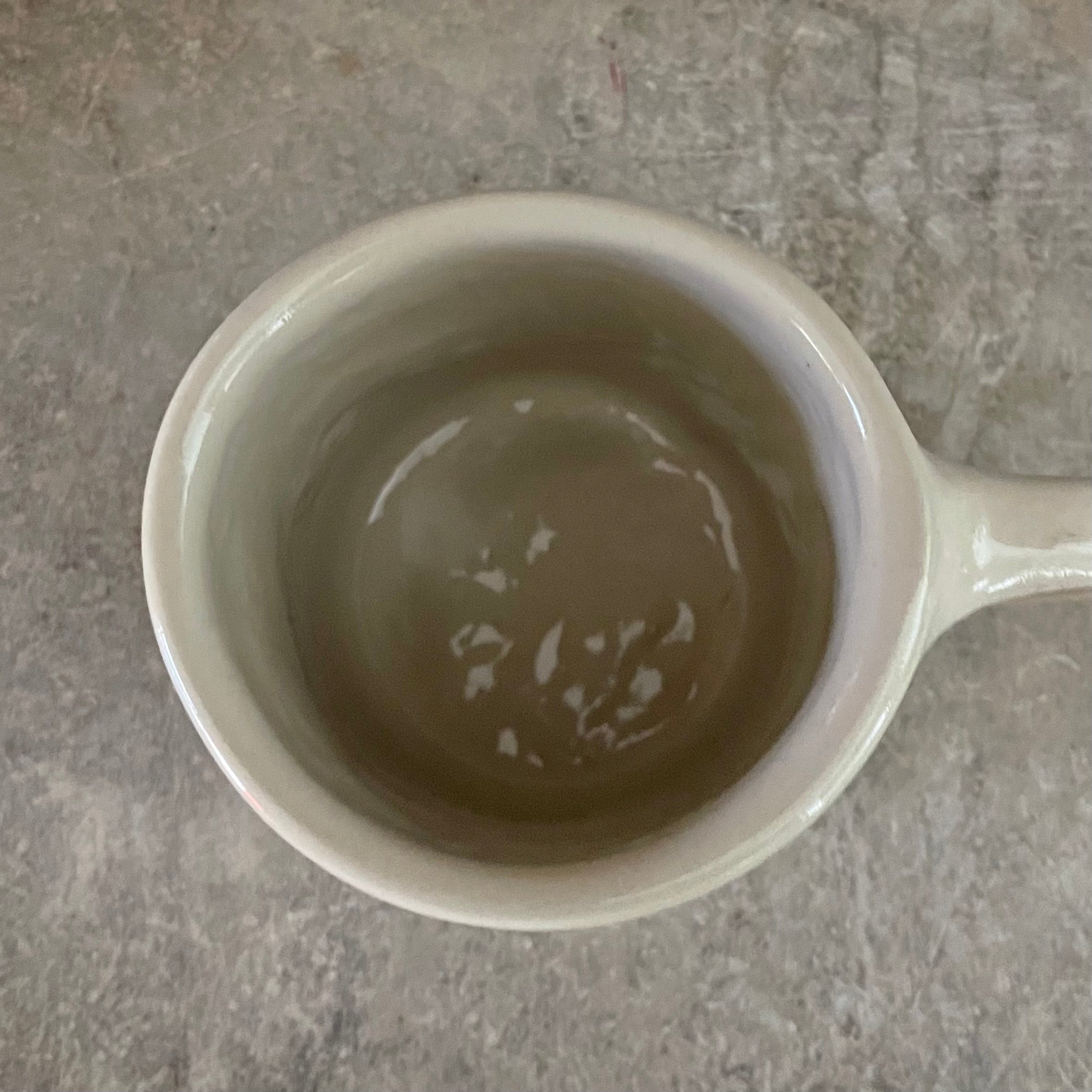 White irregular mug with words about work