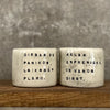 A set of small mugs with words in Lithuanian