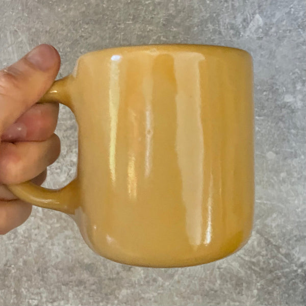 Yellow mug with words in Lithuanian