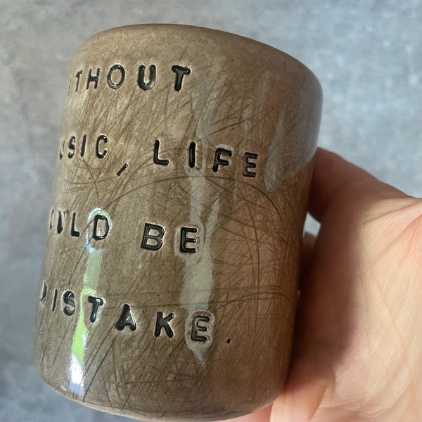 Brown mug with Nietzsche quote