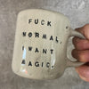Ceramic mug with saying about magic