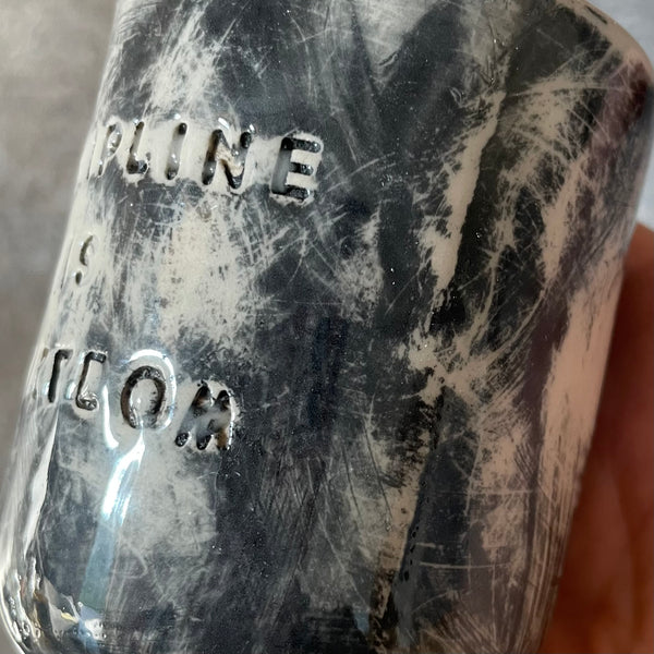 Small dark mug about discipline