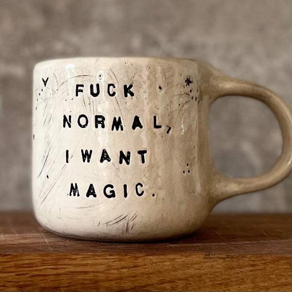 Ceramic mug with saying about magic