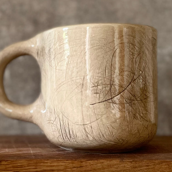Big beige mug with saying in Lithuanian