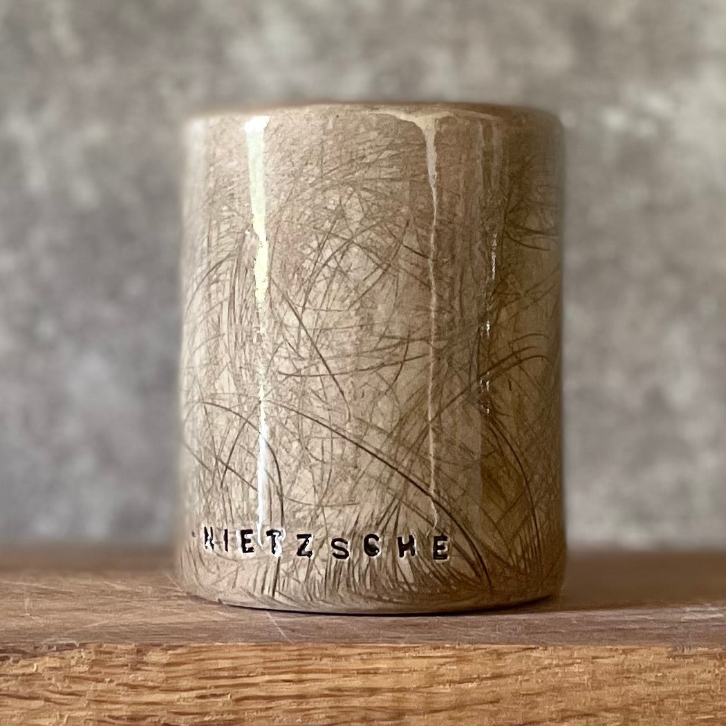 Brown mug with Nietzsche quote