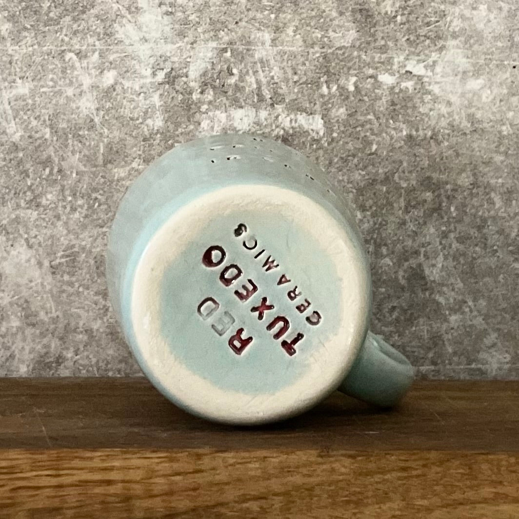 Small blue mug with words in Lithuanian