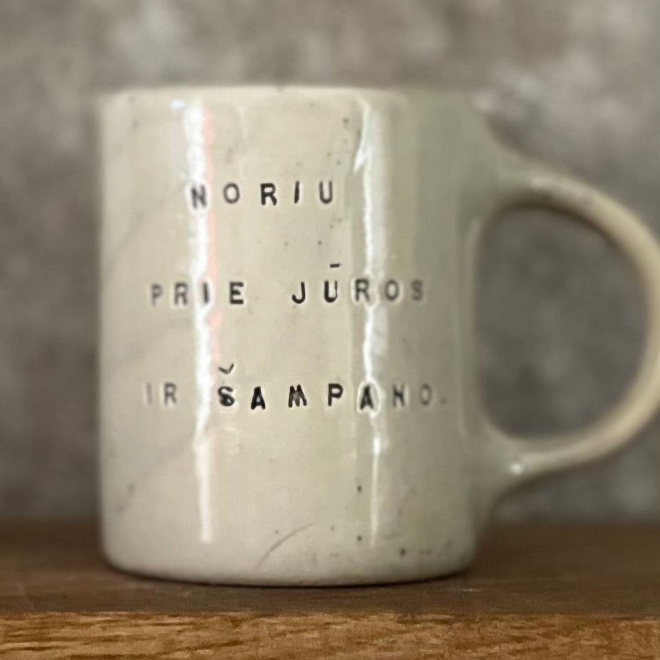 Speckled mug about champagne and the sea