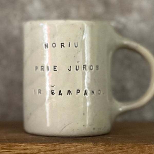 Speckled mug about champagne and the sea