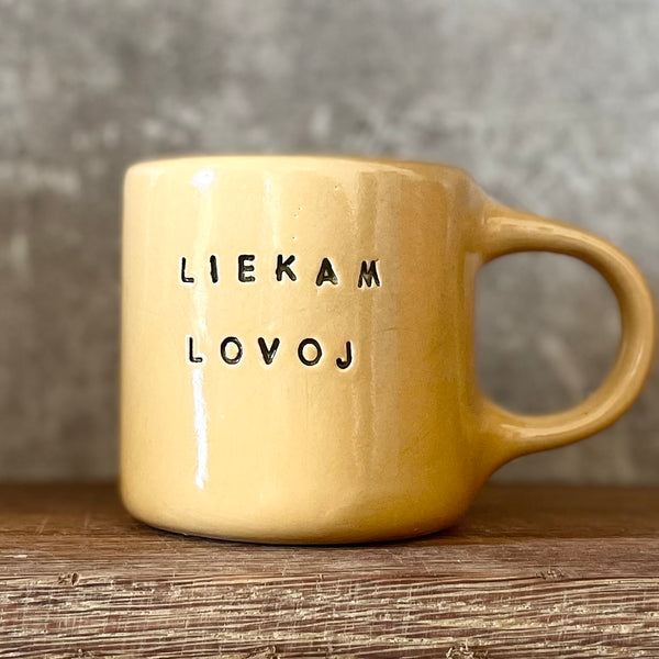 Yellow mug with words in Lithuanian