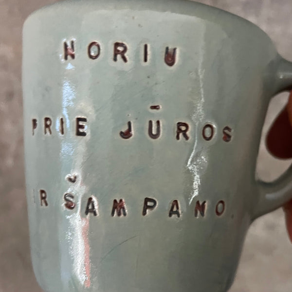Small blue mug with words in Lithuanian