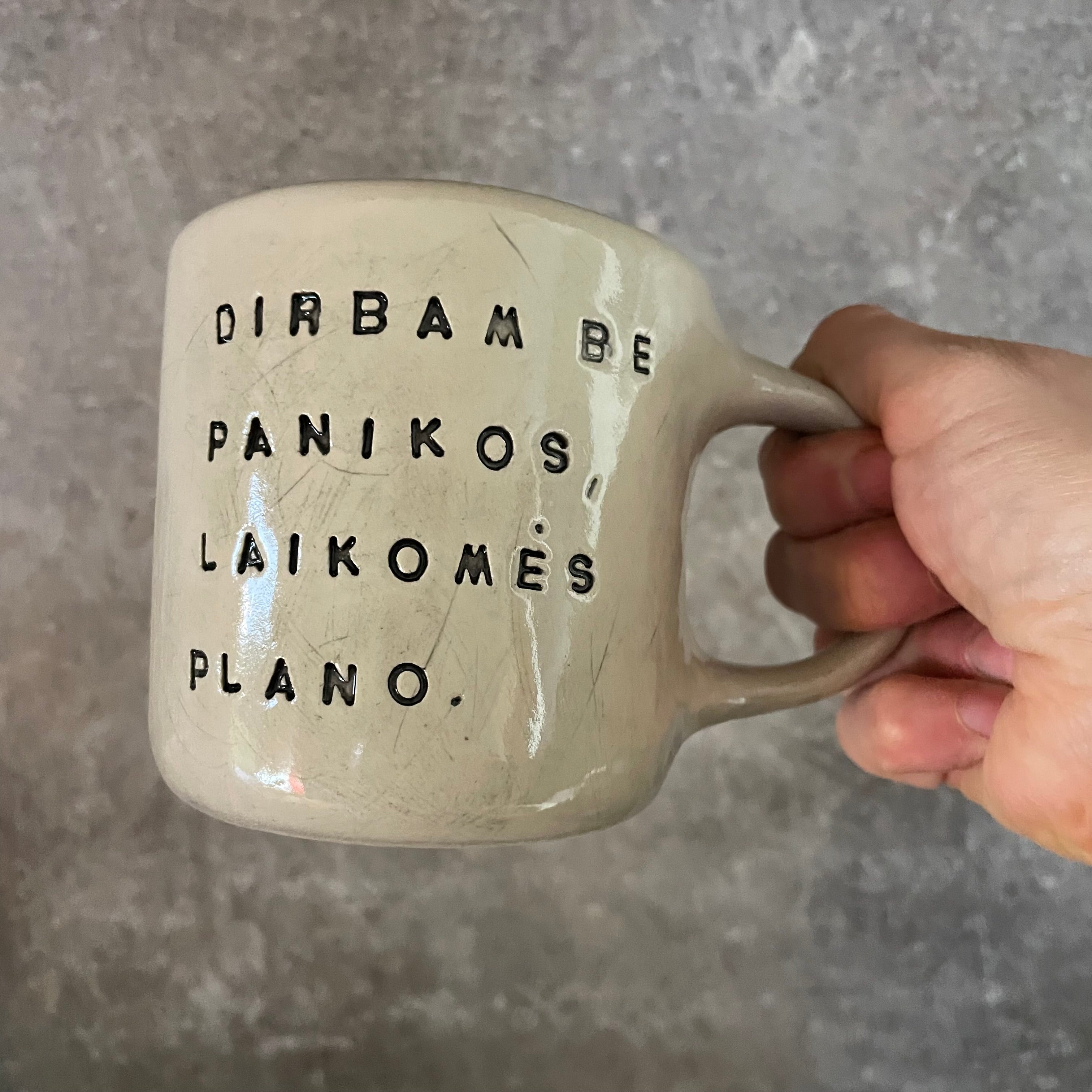 White irregular mug with words about work