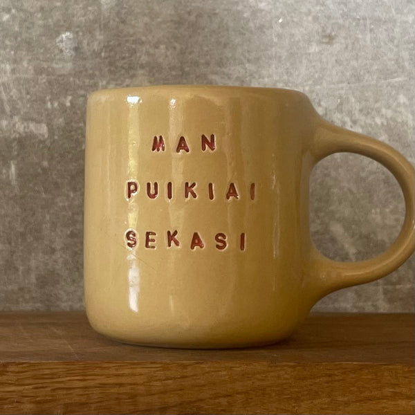 Yellow ceramic mug about luck