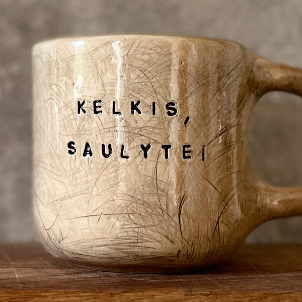 Big beige mug with saying in Lithuanian