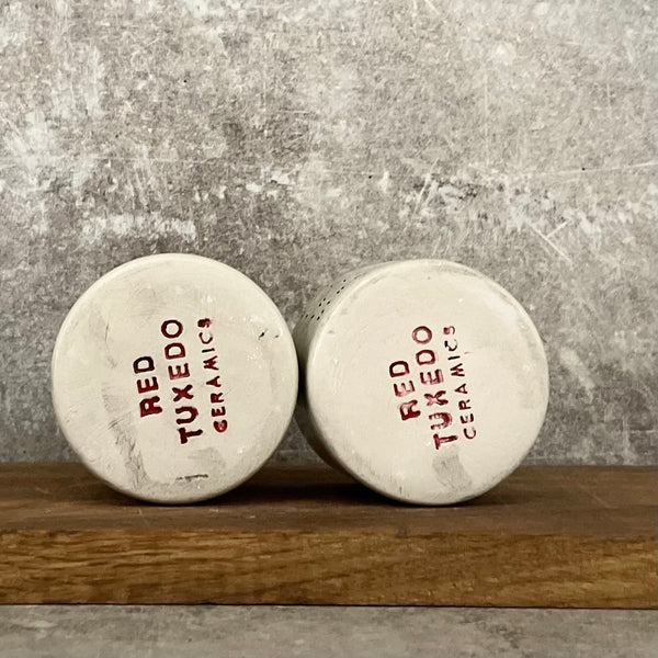 A set of small mugs with words in Lithuanian