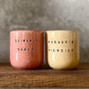 A pair of mugs with words in Lithuanian