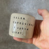 A set of small mugs with words in Lithuanian