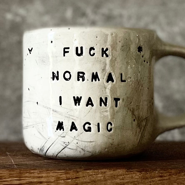 Ceramic mug with saying about magic