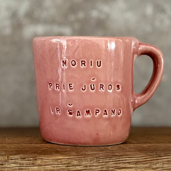 Small pink mug with words in Lithuanian