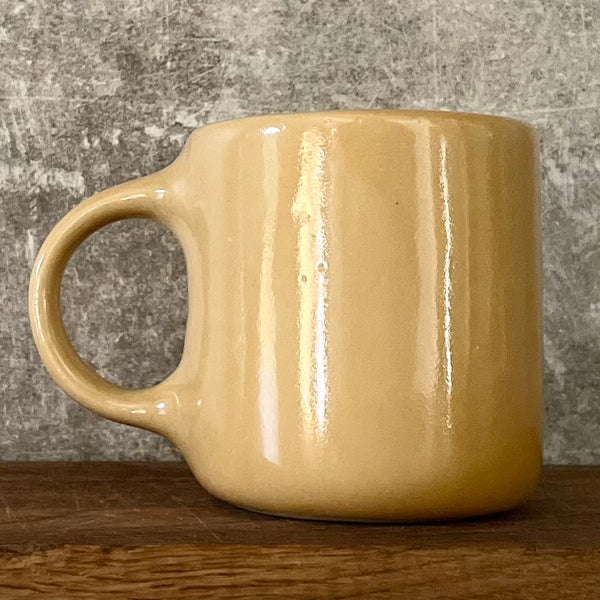 Yellow mug with words in Lithuanian