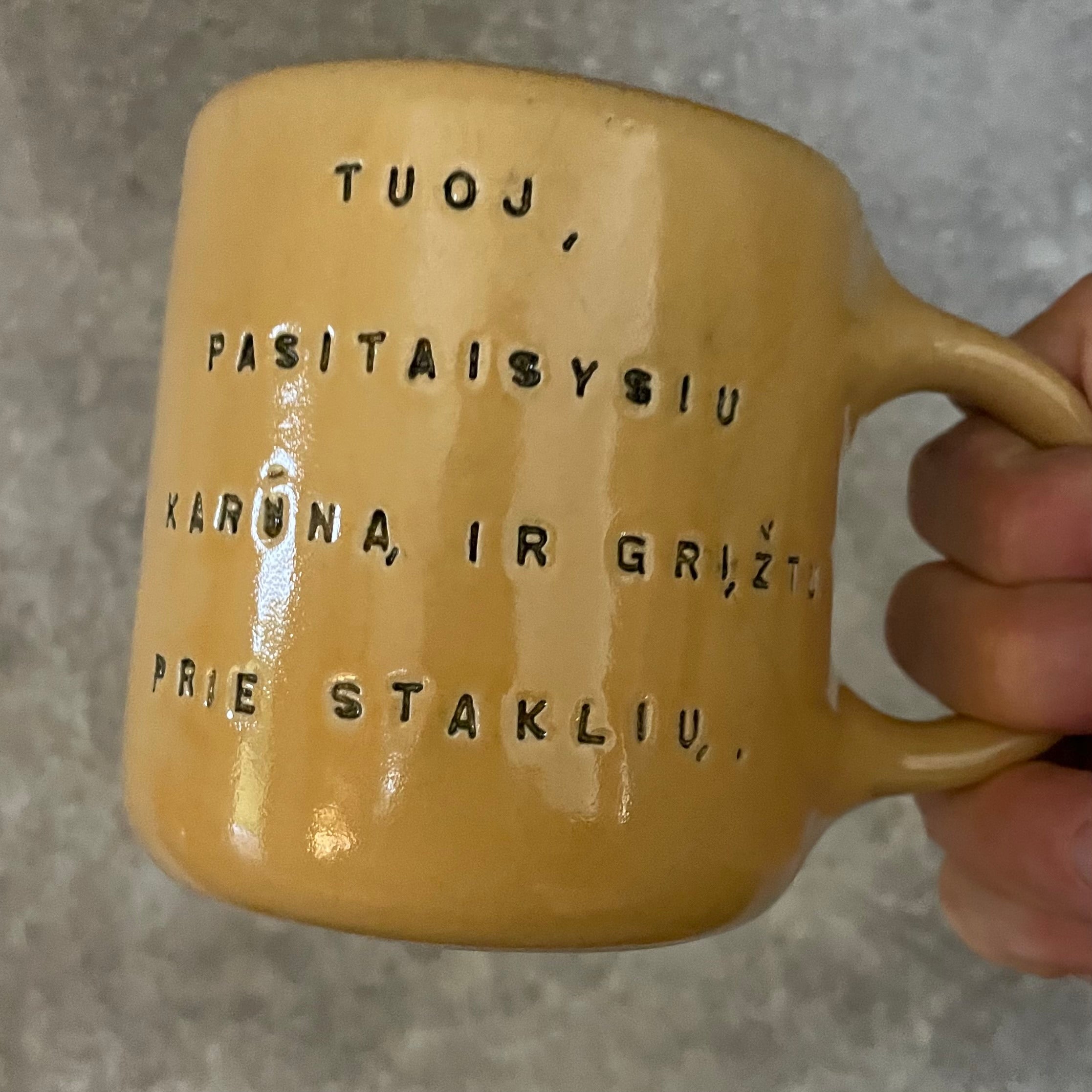 Yellow mug with words in Lithuanian