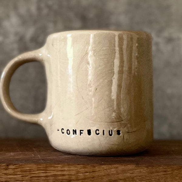 Beige mug with quote by Confucius