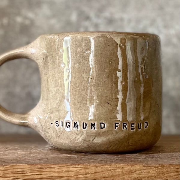 Brown mug with quote by S. Freud
