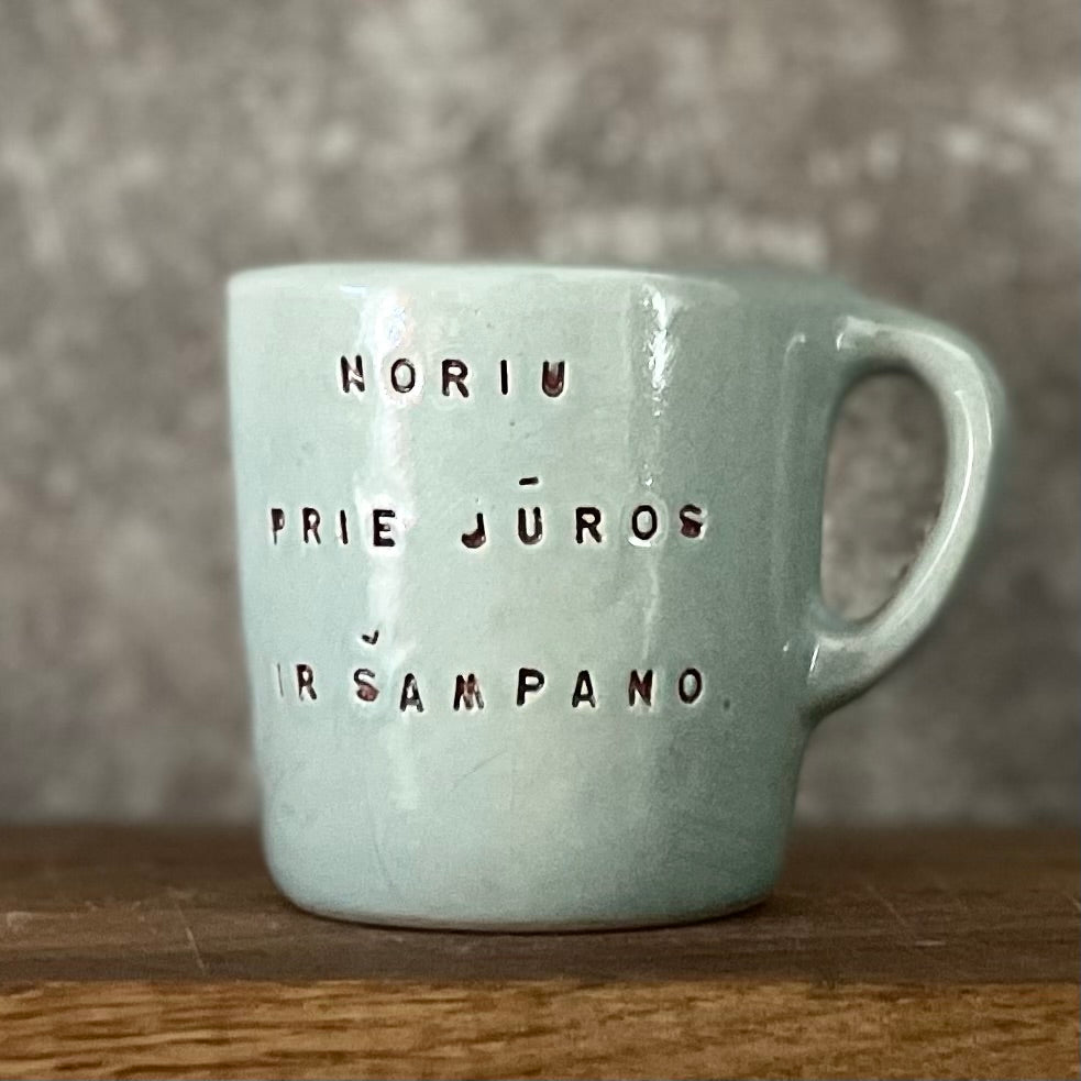 Small blue mug with words in Lithuanian