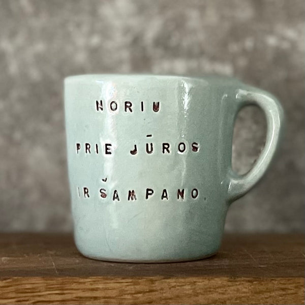 Small blue mug with words in Lithuanian