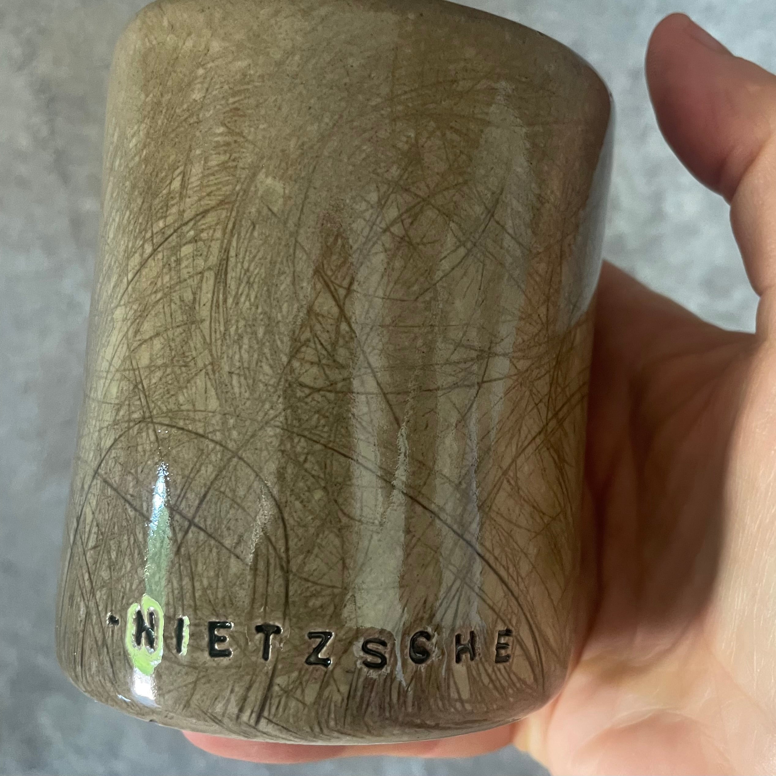 Brown mug with Nietzsche quote