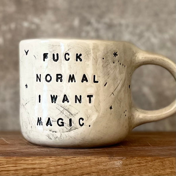 Ceramic mug with saying about magic