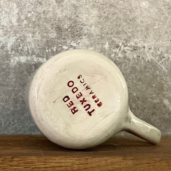 White irregular mug with words about work