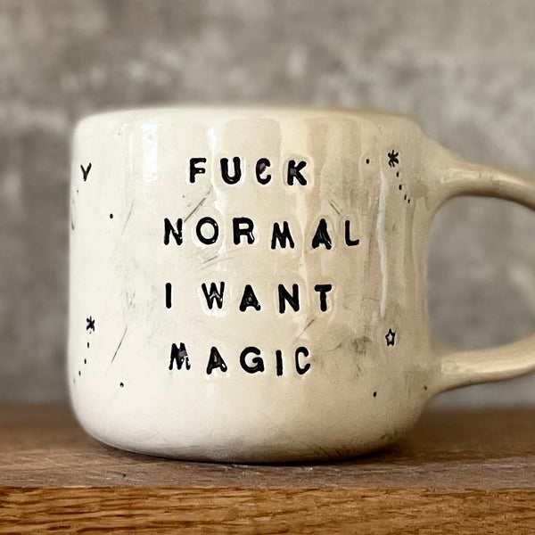 Ceramic mug with saying about magic