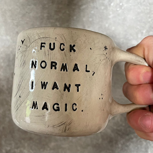 Ceramic mug with saying about magic