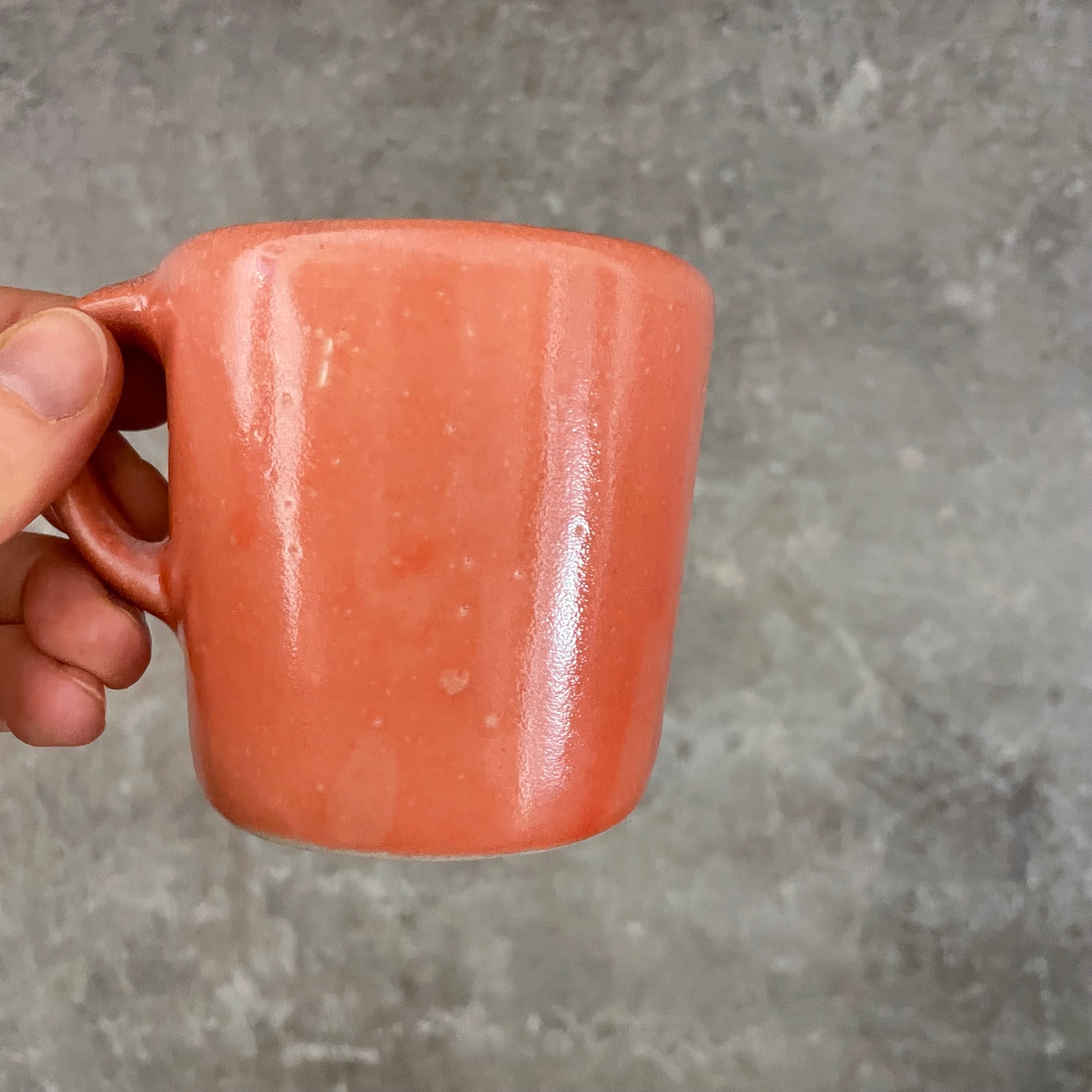 Small red mug with words in Lithuanian