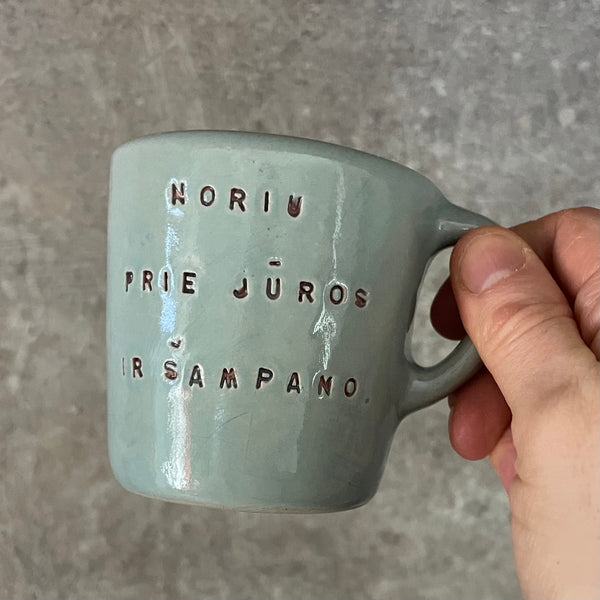Small blue mug with words in Lithuanian