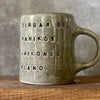 Green ceramic mug with words about work
