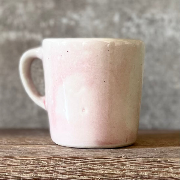 Small pink mug with words in Lithuanian
