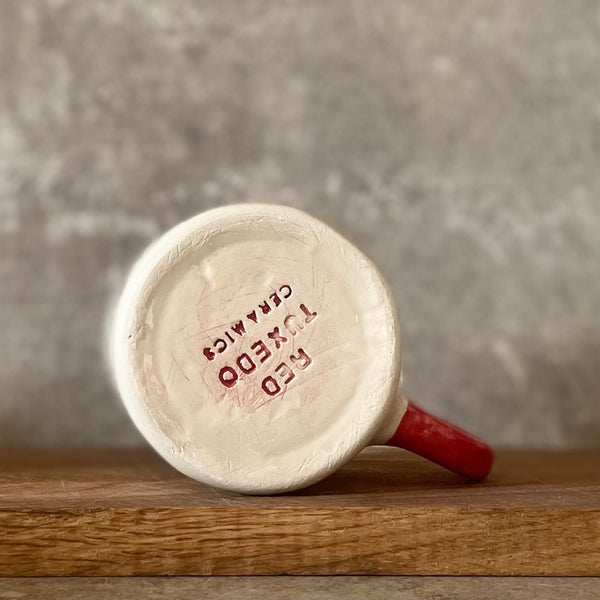 Puodelis su raudona rankena SKANIOS KAVELĖS